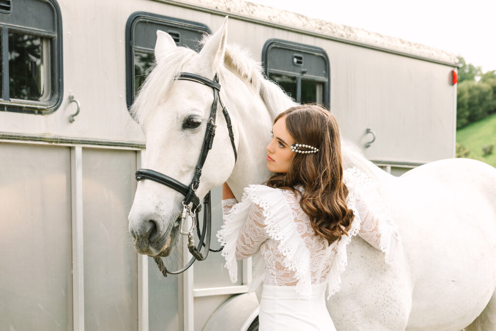 Editorial senior portrait with white horse in Danville, California — high school senior girl in lace blouse photographed by Shawna Tomren, senior portrait photographer
